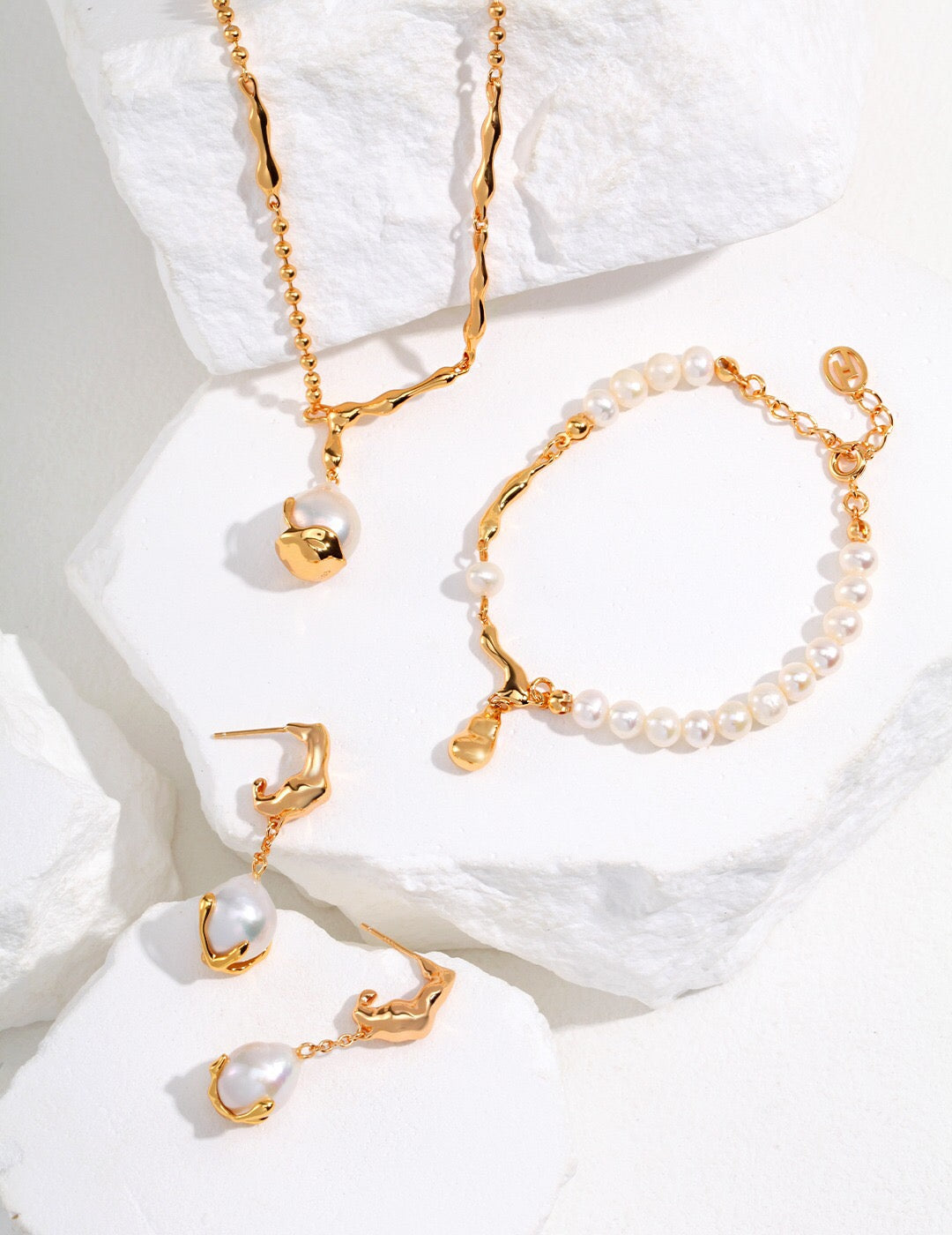 Matching handmade jewelry set with Dangle Teardrop Pearl Earrings, pearl bracelet, and necklace in 18k gold-plated finish and freshwater pearls.