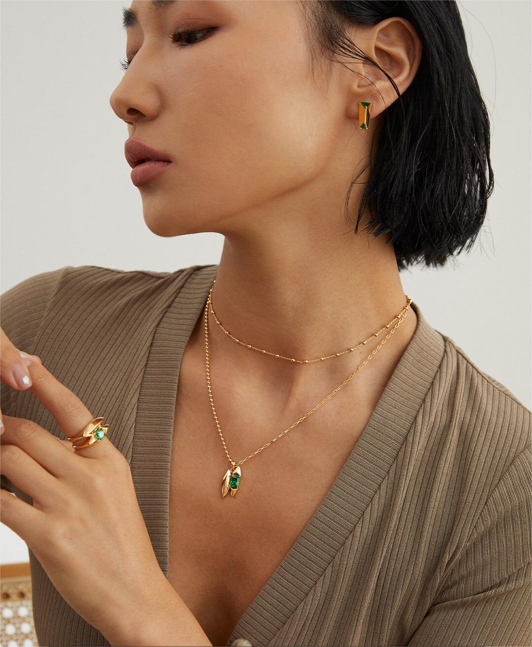 Model showcasing full Handmade Green Zircon Jewelry set including necklace, ring, and earrings in gold vermeil with green gemstones.