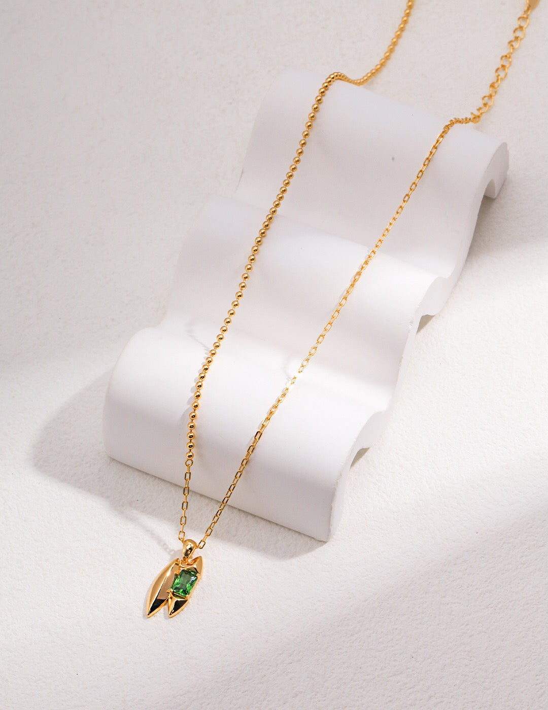 Close-up of Handmade Green Zircon Necklace in gold vermeil, showcasing a green zircon pendant on an adjustable gold-plated chain.