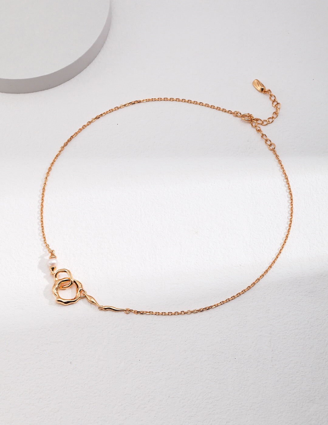 Gold Roundness Hollow Round Pearl Necklace with a freshwater pearl and artistic loop pendant on a fine adjustable chain.