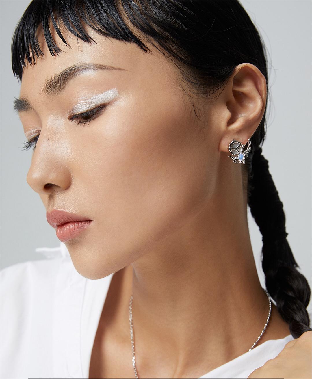 Side view of model wearing silver Crescent Moon Style Asymmetrical Opal Stud Earring, emphasizing its elegant and modern design.