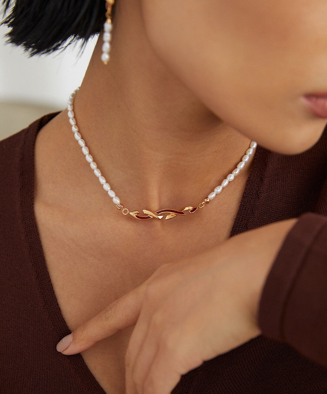 Model wearing the gold Awareness Ribbon Necklace with natural pearls, showcasing elegant and hypoallergenic jewelry for everyday wear.