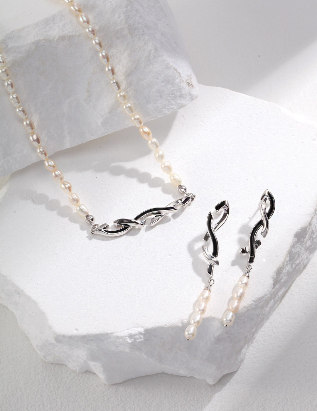 Geometric Pearl Necklace and matching earrings in silver-tone awareness ribbon design, handcrafted with freshwater pearls and hypoallergenic finish.