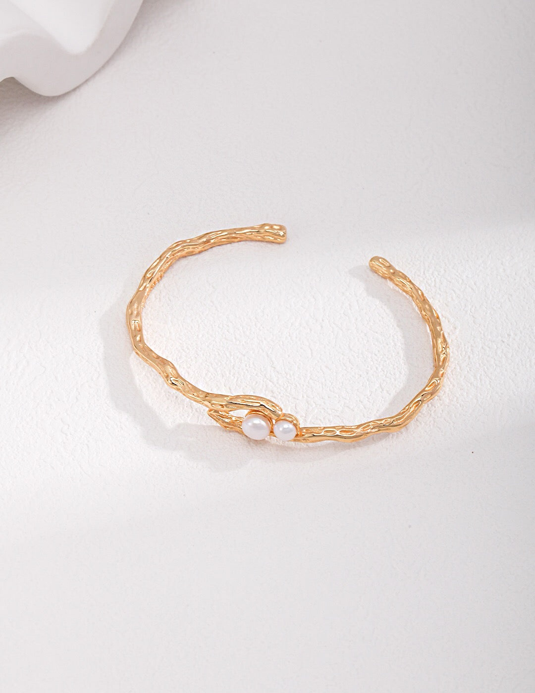 Double-Pearl Cuff Bracelet - Handmade Pearl Cuff with freshwater pearls and 18k gold-plated twisted band, displayed on white background.