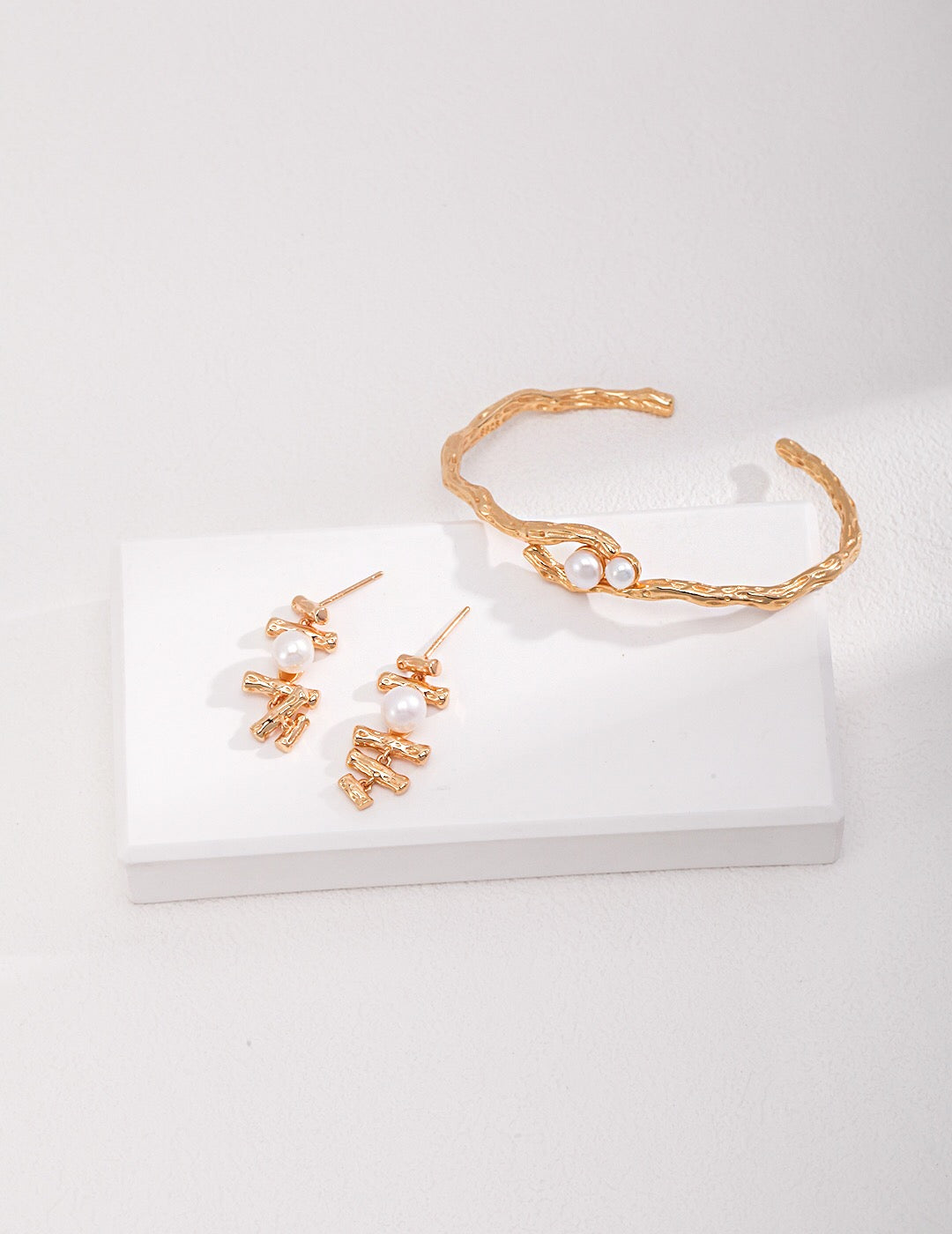 Double-Pearl Cuff Bracelet paired with matching gold and pearl earrings, showcasing a cohesive handmade jewelry set.