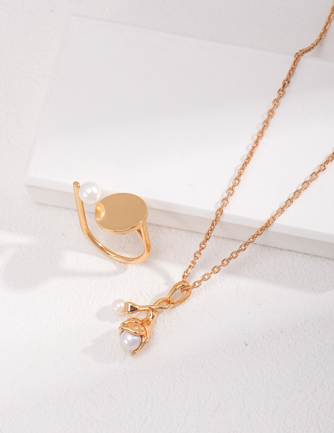 Soft cream jewelry pouch with button closure for Gold Pearl Pendant Necklace. Ideal for safe storage or elegant gift presentation.