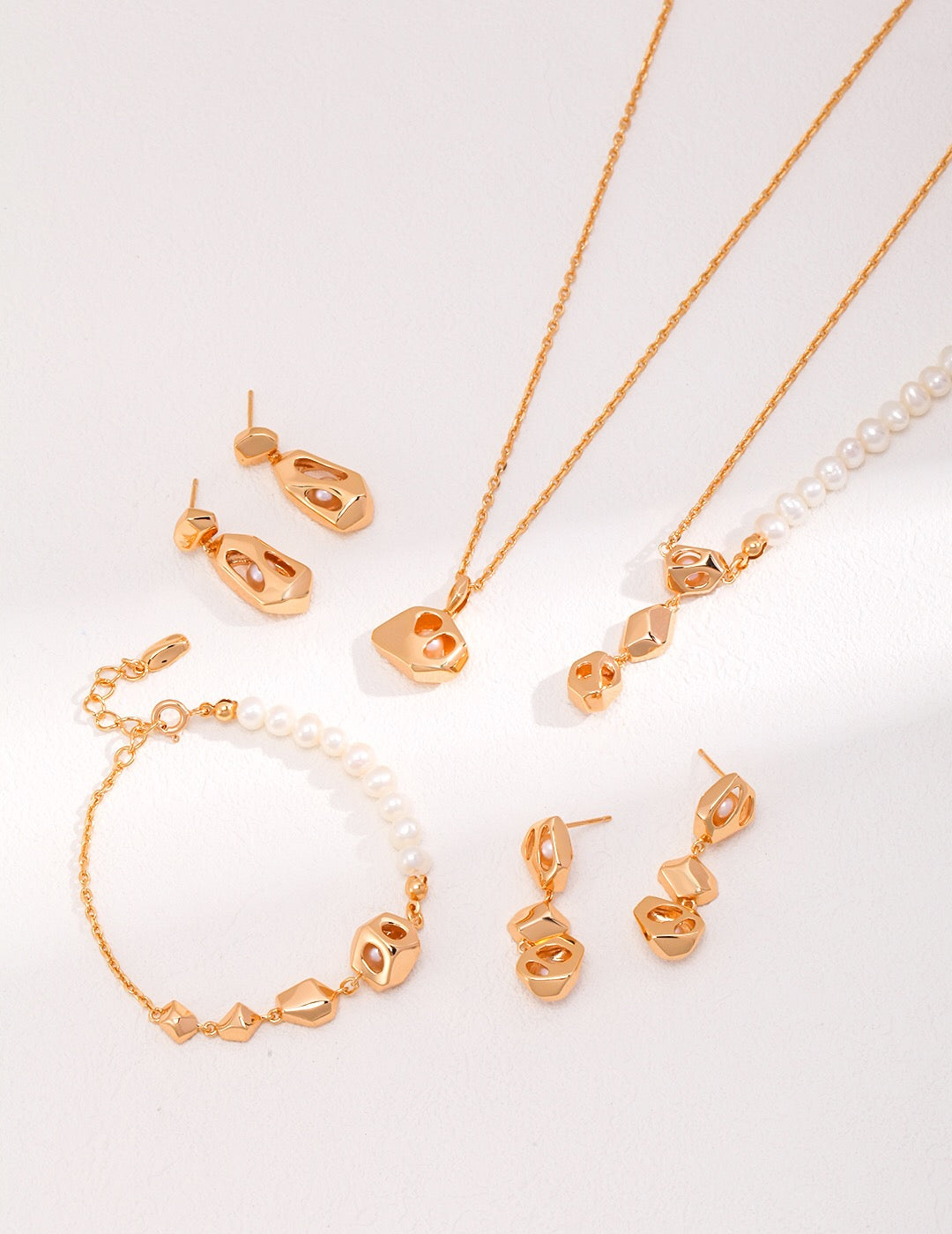 Complete jewelry set with handmade gold openwork pearl earrings, necklaces, and bracelets featuring freshwater pearls and hypoallergenic design.