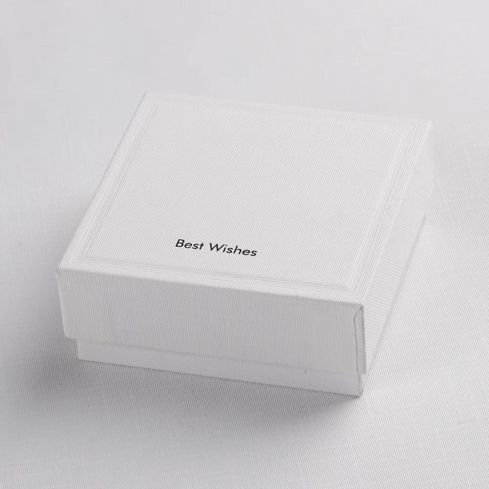 Elegant white jewelry gift box with 'Best Wishes' text, perfect for gifting the Adjustable Wave Pearl Cuff Bracelet.