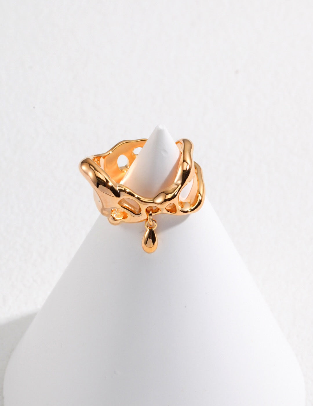 Gold-plated Minimalist Irregular Teardrop Pendant Ring with open design and teardrop charm, shown on a white cone jewelry stand.