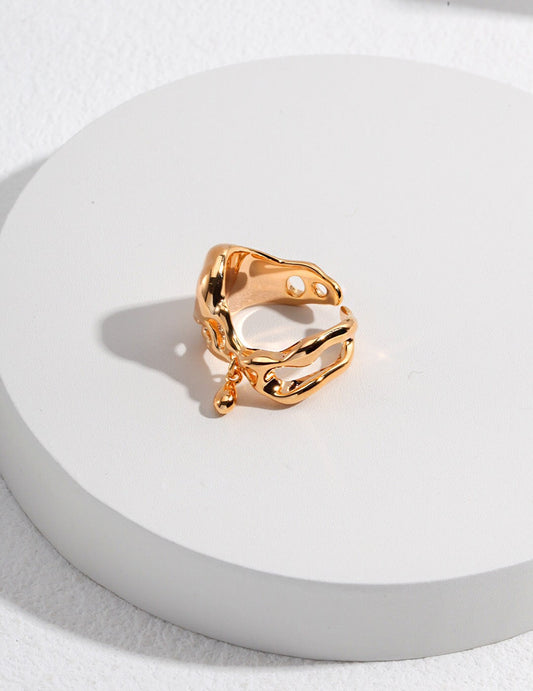 Teardrop Ring - Minimalist Pendant in 18k gold-plated finish with irregular open band and dangling charm, displayed on white round platform.