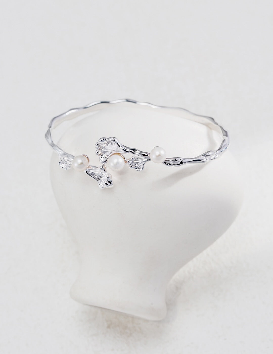 Adjustable Wave Pearl Cuff Bracelet in silver-plated sterling silver with natural pearls, hypoallergenic and tarnish-resistant design.