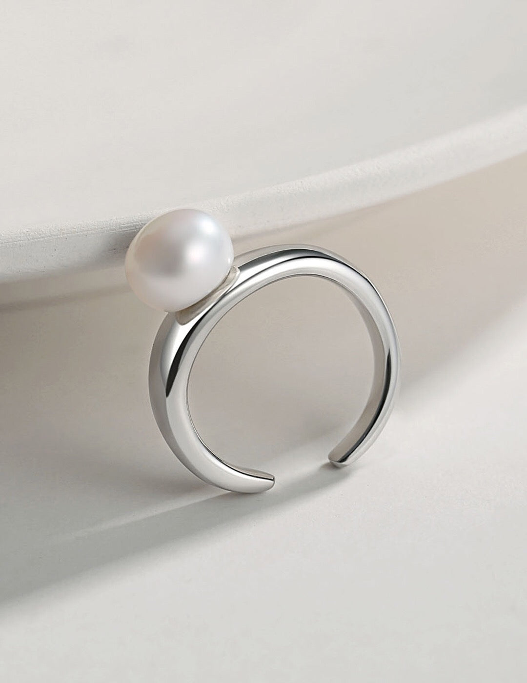 Silver-toned Freshwater Pearl Open Tail Ring with minimalist design. Adjustable and hypoallergenic, ideal for modern jewelry collections.