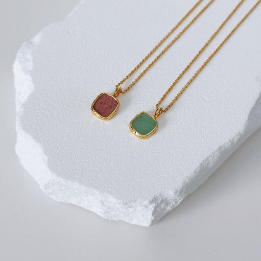 Gold Healing Necklace featuring handmade Rhodochrosite and Green Aventurine pendants on adjustable gold vermeil chains, displayed on white stone.