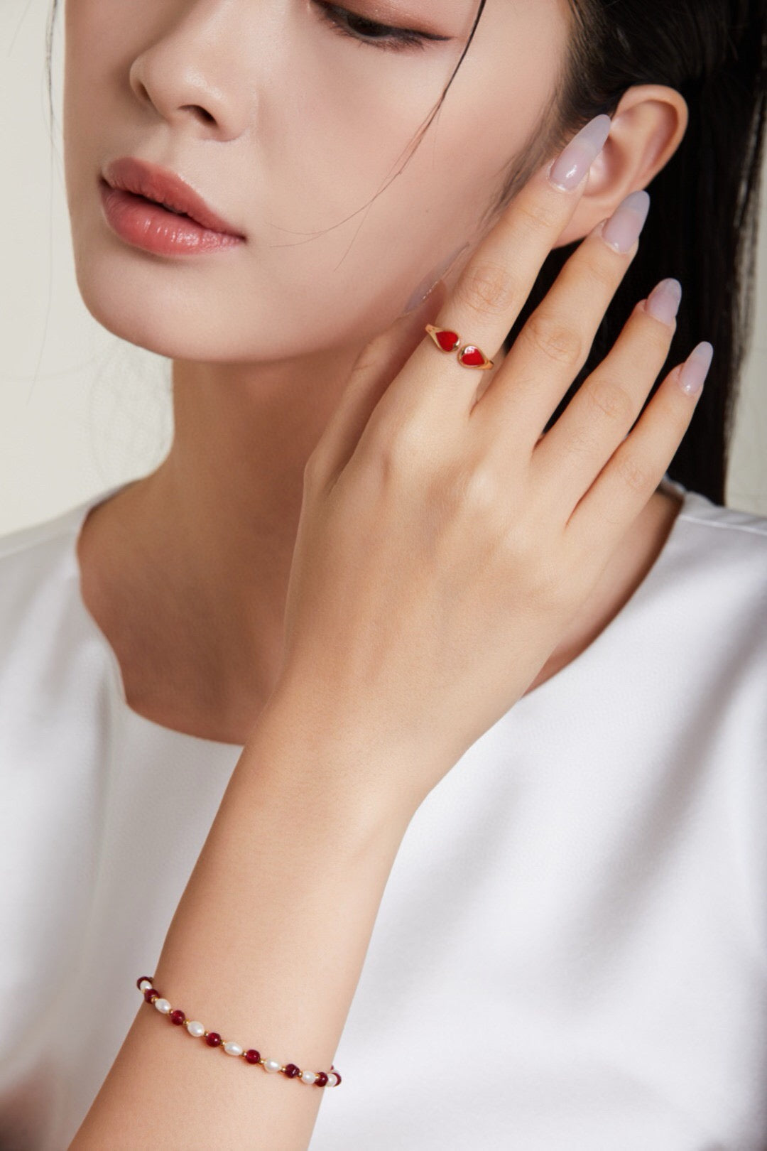 Model wearing the Heart Shaped Ring - Gold Vermeil Adjustable with red enamel hearts, paired with a matching bracelet for a coordinated look.