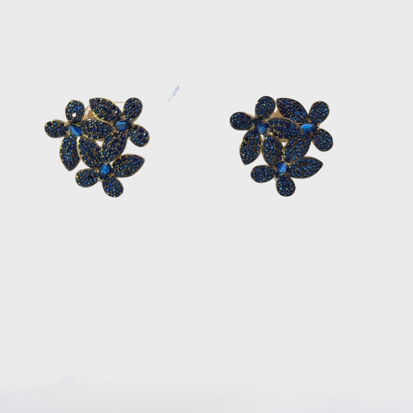Isolated view of sapphire blue floral stud earrings with gold trim, perfect for showcasing product details in e-commerce listings.